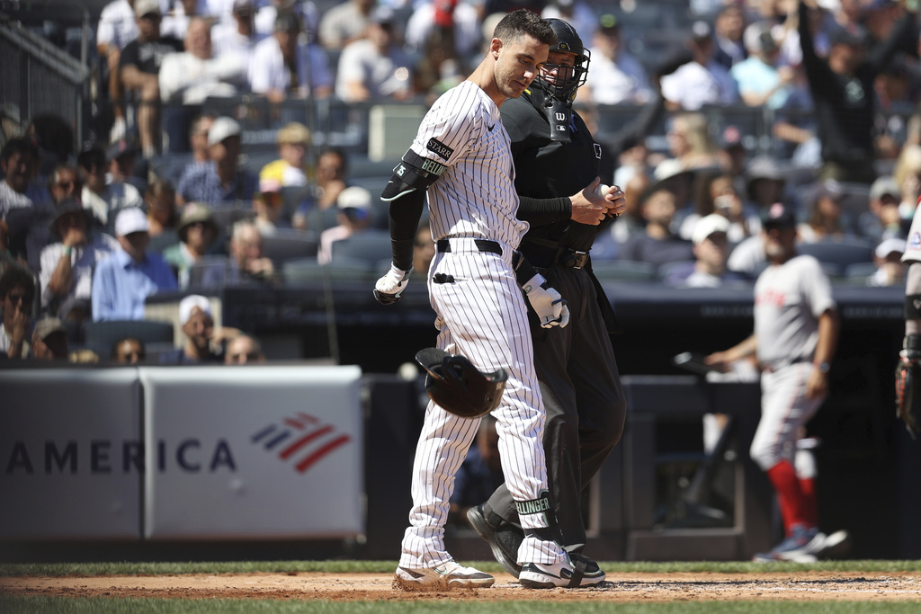 New York Yankees' Cody Bellinger throws his helmet on the ground after being called out on strikes during the third inning of a baseball game against the Boston Red Sox, Saturday, Aug. 23, 2025, in New York. (AP Photo/Pamela Smith)
