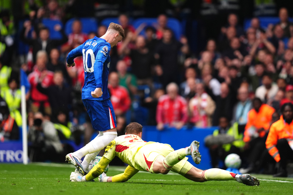 Nottingham Forest goalkeeper Matz Sels, right, claims the ball from Chelsea's Cole Palmer after he missed penalty kick during the English Premier League soccer match between Chelsea and Nottingham Forest in London, Monday, May 4, 2026. (John Walton/PA via AP)