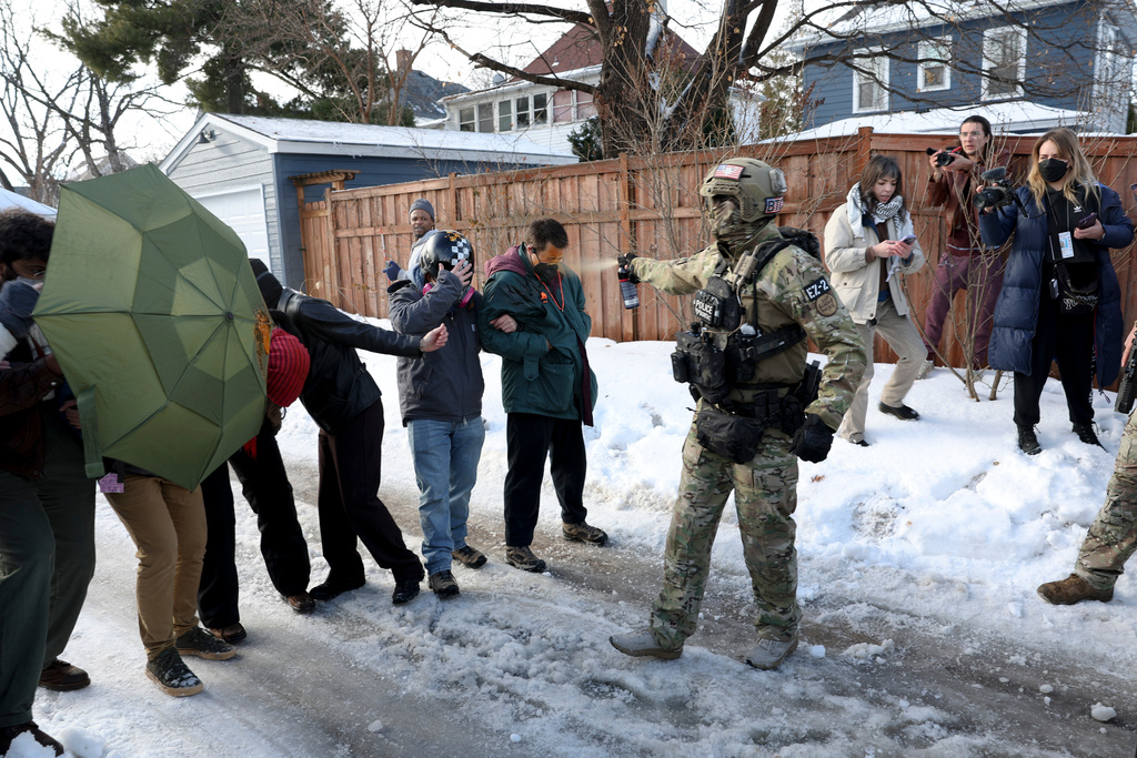 A federal agent sprays a protester with a chemical agent at the scene of a shooting in Minneapolis on Wednesday, Jan. 7, 2026. (Ellen Schmidt/MinnPost via AP)