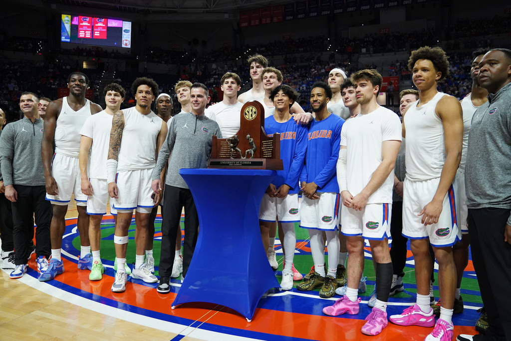Florida celebrates their SEC regular season trophy prior to taking on Mississippi State during the first half of an NCAA college basketball game, Tuesday, March 3, 2026, in Gainesville, Fla. (AP Photo/Morgan Hurd)