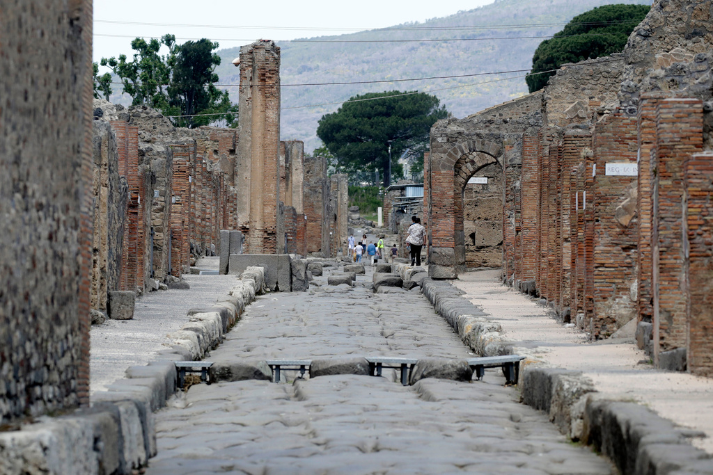 FILE -People visit the archaeological site of Pompeii, near Naples, southern Italy,Tuesday, May 26, 2020. (AP Photo/Alessandra Tarantino, File)