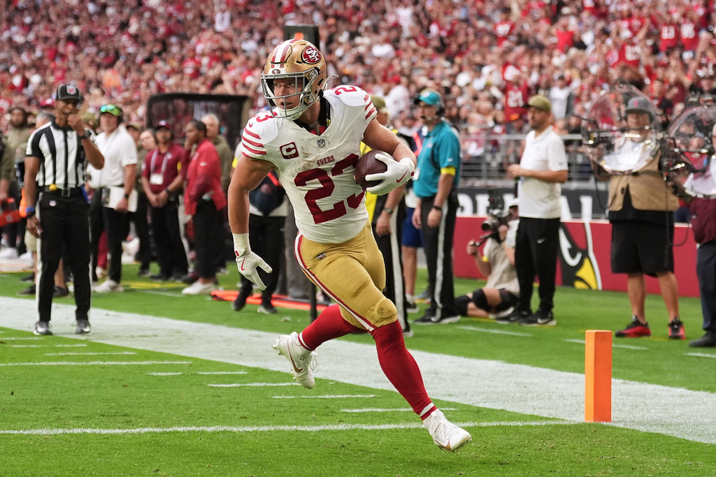 San Francisco 49ers running back Christian McCaffrey (23) scores against the Arizona Cardinals during the first half of an NFL football game in Glendale, Ariz., Sunday, Nov. 16, 2025. (AP Photo/Ross D. Franklin)