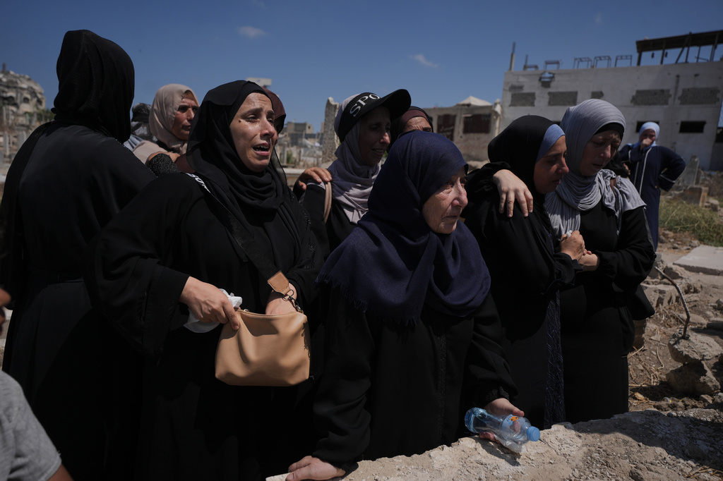 Mourners attend the funeral Palestinians killed in Israeli strikes during the war with Hamas, whose remains were recently recovered from the rubble, in Gaza City, Thursday, Aug. 20, 2026. (AP Photo/Jehad Alshrafi)