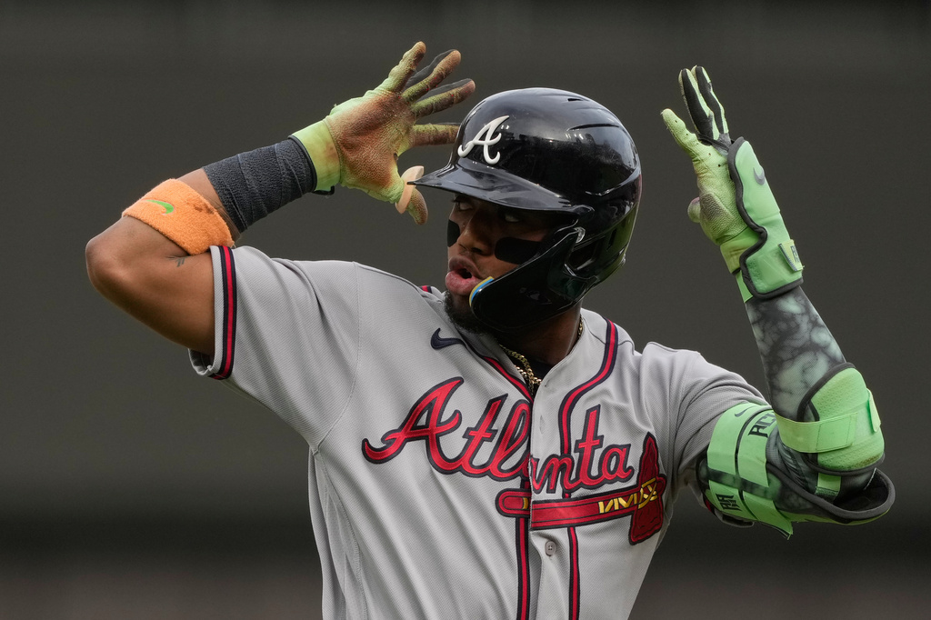 Atlanta Braves right fielder Ronald Acuña Jr. reacts as he round third base after hitting a solo home run during the first inning of a baseball game against the Cincinnati Reds in Cincinnati, Friday, May 29, 2026. (AP Photo/Carolyn Kaster)
