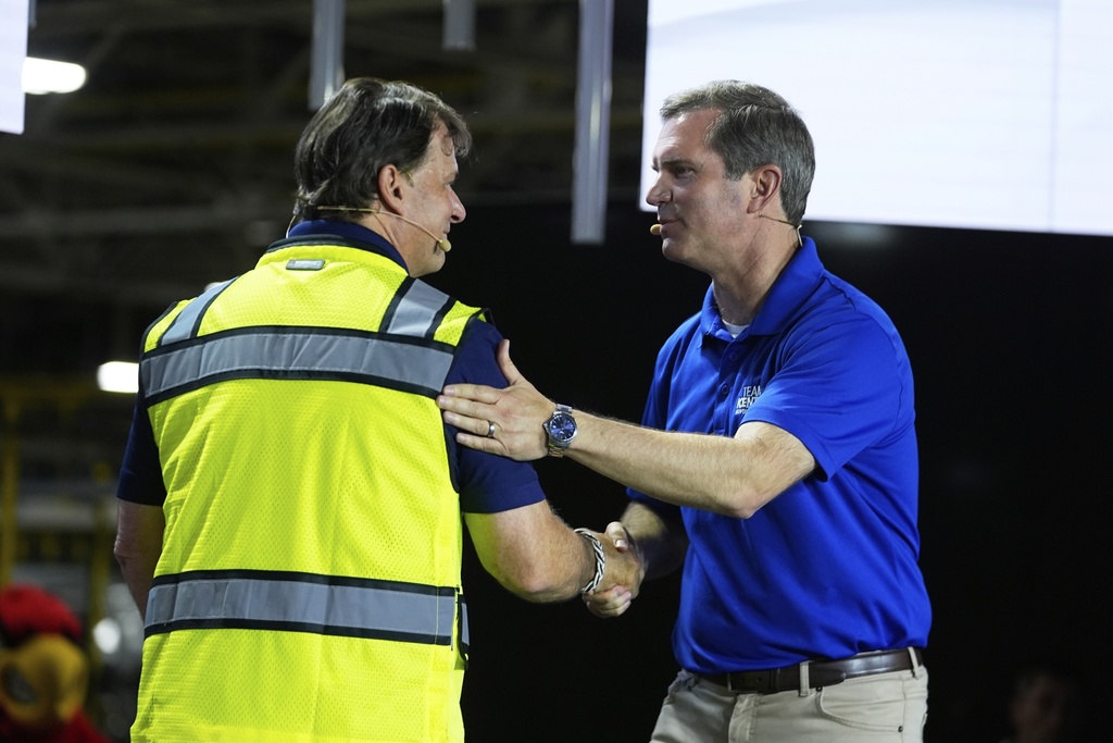 Ford CEO Jim Farley, left, shakes hands with Kentucky Governor Andy Beshear at the Louisville Assembly Plant, Monday, Aug. 11, 2025, in Louisville, Ky. (AP Photo/Darron Cummings)