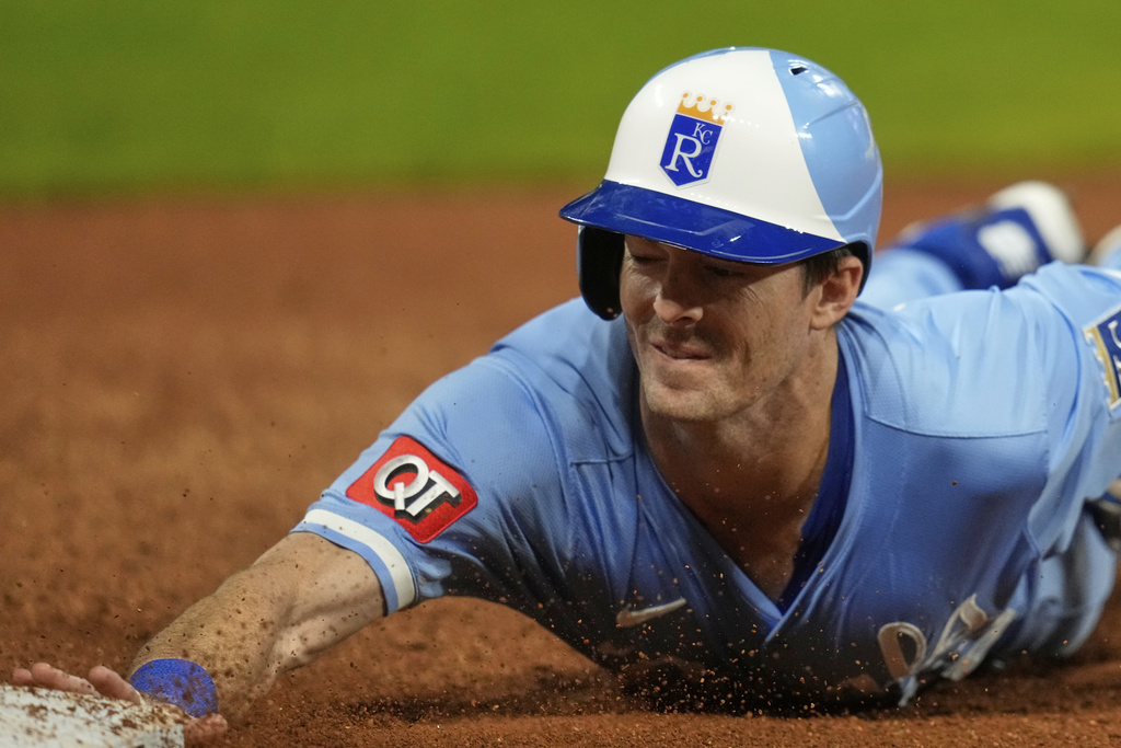 Kansas City Royals' Mike Yastrzemski gets back safely to first base on a pick off attempt in the seventh inning of a baseball game against the Cleveland Guardians in Cleveland, Thursday, Sept. 11, 2025. (AP Photo/Sue Ogrocki)