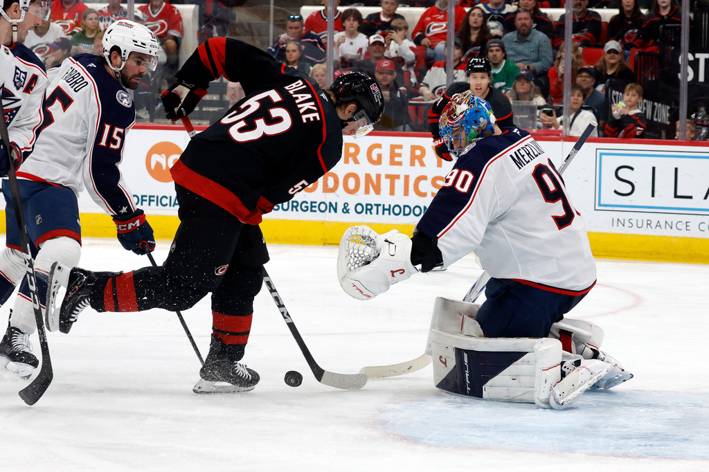 Carolina Hurricanes' Jackson Blake (53) tries to control the puck in front of Columbus Blue Jackets goaltender Elvis Merzlikins (90) during the second period of an NHL hockey game in Raleigh, N.C., Thursday, April 2, 2026. (AP Photo/Karl DeBlaker)