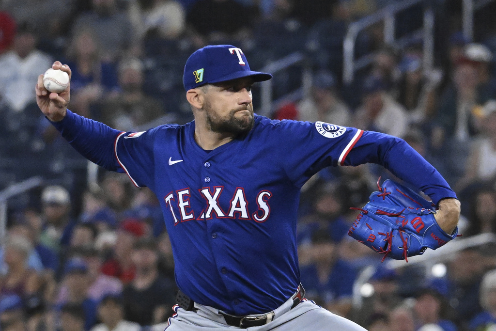 Texas Rangers starting pitcher Nathan Eovaldi throws to a Toronto Blue Jays batter in first-inning baseball game action in Toronto, Sunday, Aug. 17, 2025. (Jon Blacker/The Canadian Press via AP)