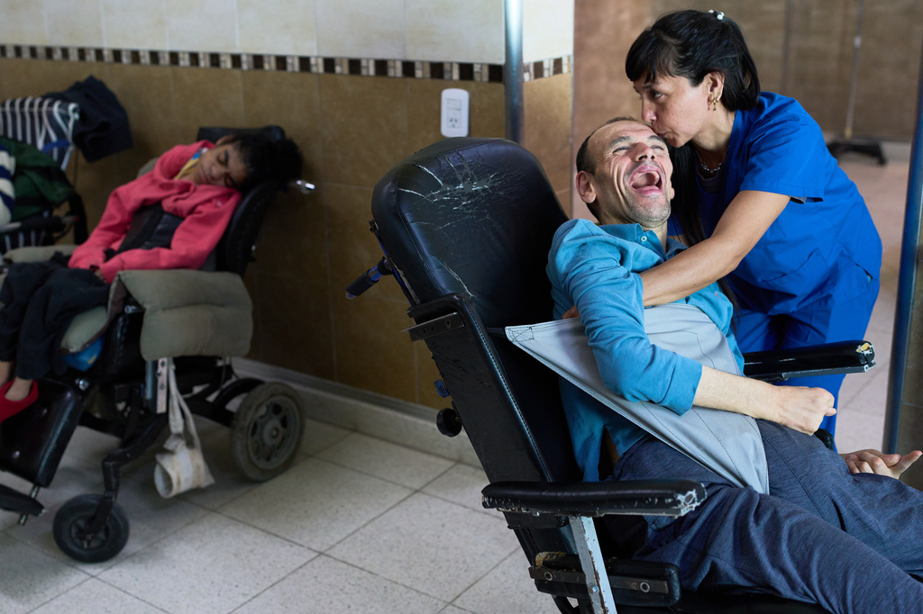 Employee Giselle Correa kisses resident Flavio Mendez in the Pequeño Cottolengo Don Orione, a home for people with disabilities that will be visited by Pope Leo XIV in November, in Buenos Aires, Argentina, Thursday, Sept. 24, 2026. (AP Photo/Rodrigo Abd)