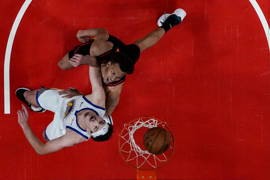 Atlanta Hawks guard Dyson Daniels (5) shoots against Golden State Warriors center Quinten Post (21) during the first half of an NBA basketball game, Saturday, March 21, 2026, in Atlanta. (AP Photo/Mike Stewart)