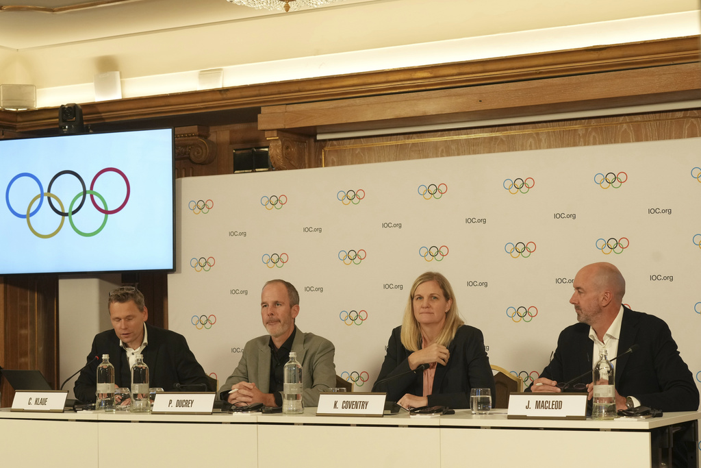 IOC President Kirsty Coventry, second right, attends a final press conference with Executive Board members Christian Klaue, left, Pierre Ducrey, second left, and James Macleod after visiting Olympic and Paralympic Village and various venues in Milan, Italy, Friday, Sept. 19, 2025. (AP Photo/Antonio Calanni)