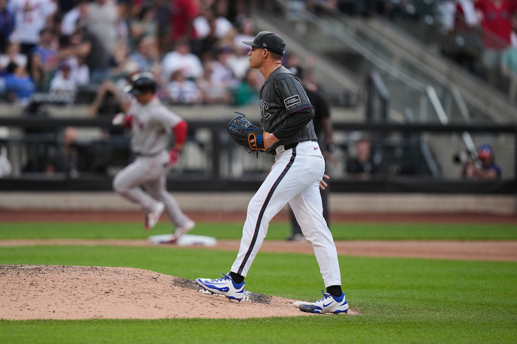 New York Mets pitcher Tobias Myers, right, reacts as Boston Red Sox's Masataka Yoshida runs the bases after hitting a two-run home run during the eighth inning of a baseball game Saturday, July 11, 2026, in New York. (AP Photo/Frank Franklin II)