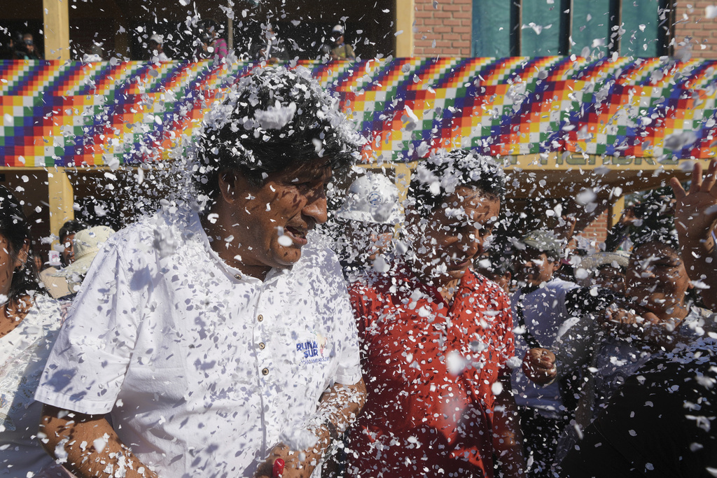Supporters throw confetti on former President Evo Morales after a meeting with a peasants' federation, before he voted in presidential and legislative elections in Villa 14 de Septiembre, in the Chapare region of Bolivia, Sunday, Aug. 17, 2025. (AP Photo/Jorge Saenz)