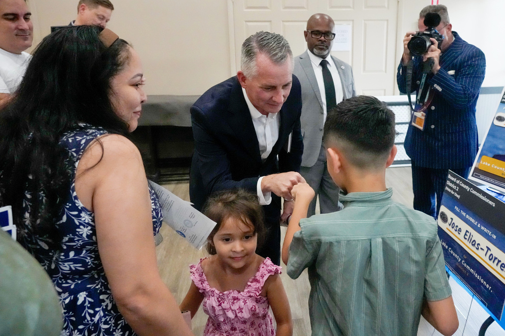 Florida Democratic gubernatorial candidate David Jolly, center, greets supporters after a town hall meeting, Saturday, Aug. 8, 2026, in Leesburg, Fla. (AP Photo/John Raoux)