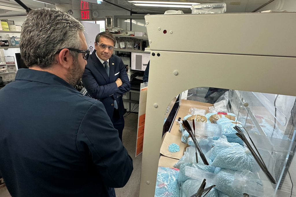 Acting Attorney General Todd Blanche talks to a technician in a Drug Enforcement Administration (DEA) mobile lab who is running tests on seized drugs in Phoenix, Wednesday, May 6, 2026. (AP Photo/Rebecca Santana)