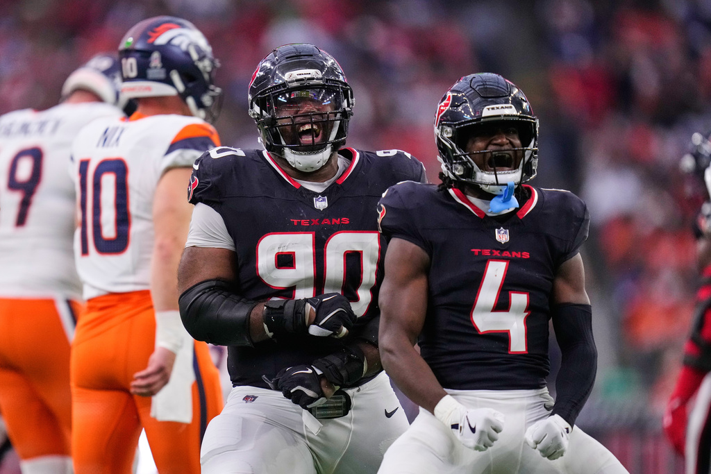 Houston Texans' Sheldon Rankins (90) and Kamari Lassiter (4) celebrate a defensive stop as Denver Broncos' Bo Nix (10) walks away in the second half of an NFL football game Sunday, Nov. 2, 2025, in Houston. (AP Photo/Eric Christian Smith)