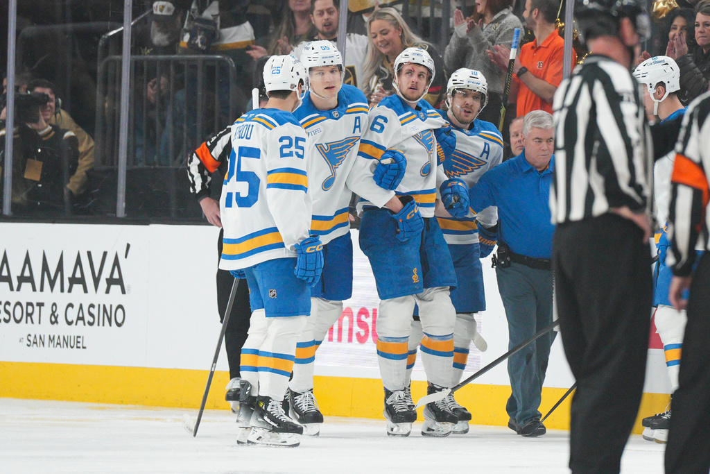 St. Louis Blues defenseman Philip Broberg is helped off the ice after being checked by Vegas Golden Knights right wing Mark Stone during the first period of an NHL hockey game, Saturday, Jan. 10, 2026, in Las Vegas. (AP Photo/Candice Ward)