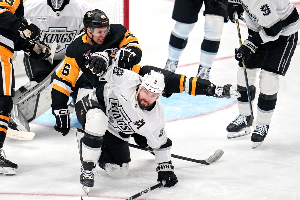 Pittsburgh Penguins' Blake Lizotte (46) collides with Los Angeles Kings' Drew Doughty (8) during the first period of an NHL hockey game in Pittsburgh, Sunday, Nov. 9, 2025. (AP Photo/Gene J. Puskar)