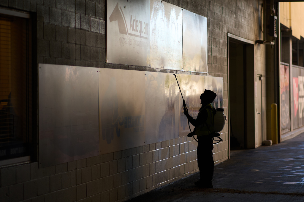 A worker disinfects walls at the South Point hotel-casino in Las Vegas Tuesday, Dec. 9, 2025, in Las Vegas. (AP Photo/John Locher)