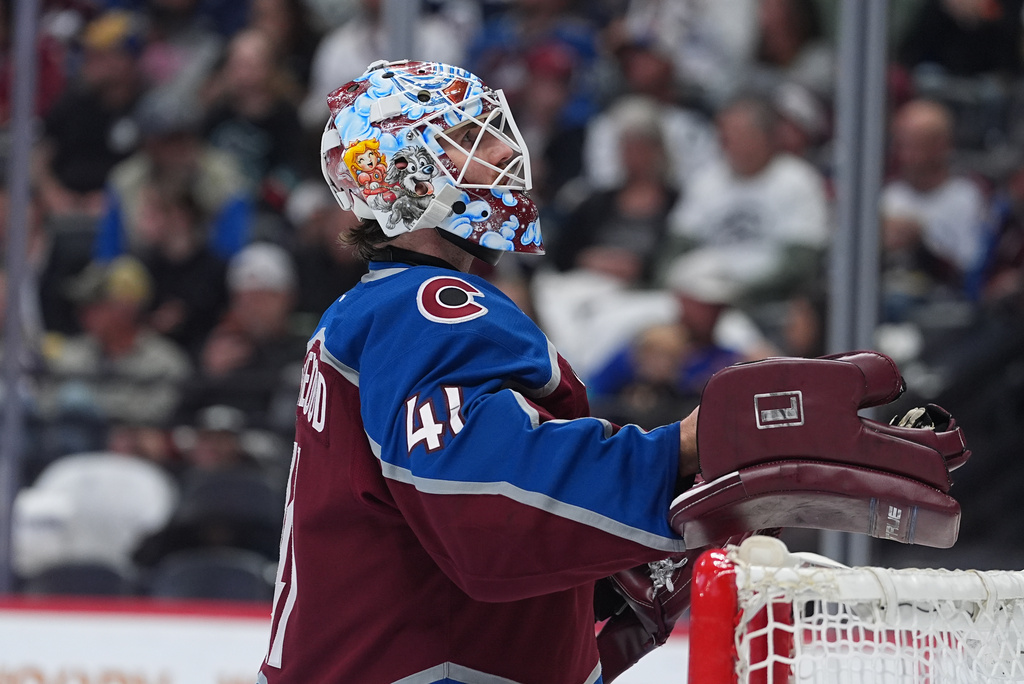 Colorado Avalanche goaltender Scott Wedgewood pulls on his gloves in the second period of an NHL hockey game against the Seattle Kraken, Thursday, April 16, 2026, in Denver. (AP Photo/David Zalubowski)