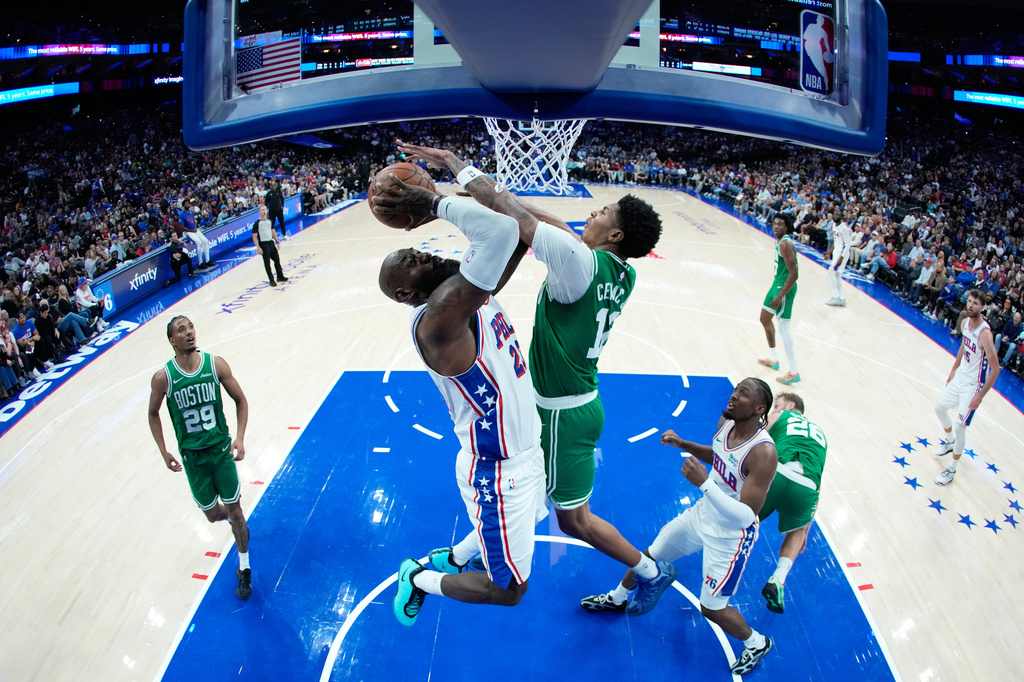 Philadelphia 76ers' LeBron James, left, goes up for a shot against Boston Celtics' Chris Cenac Jr. during the first half of a preseason NBA basketball game Friday, Oct. 16, 2026, in Philadelphia. (AP Photo/Matt Slocum)