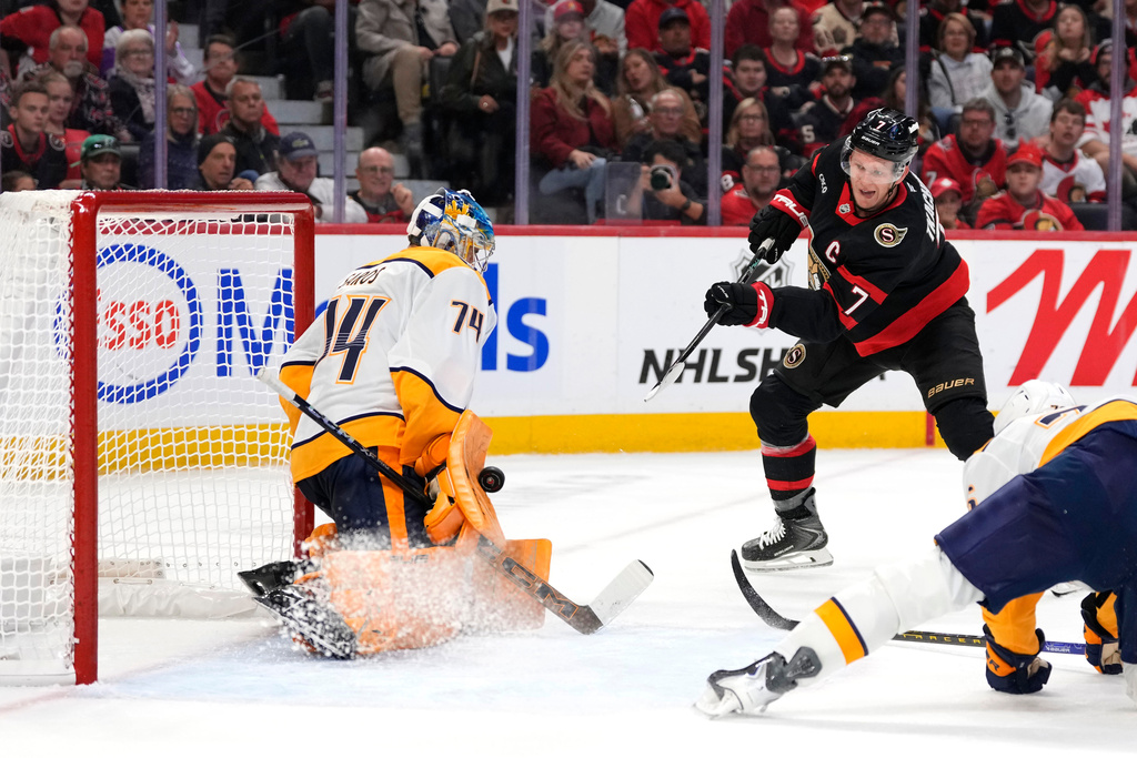 Nashville Predators goaltender Juuse Saros (74) makes a save on Ottawa Senators' Brady Tkachuk (7) during the second period of an NHL hockey game in Ottawa, Ontario, on Monday, Oct. 13, 2025. (Justin Tang/The Canadian Press via AP)