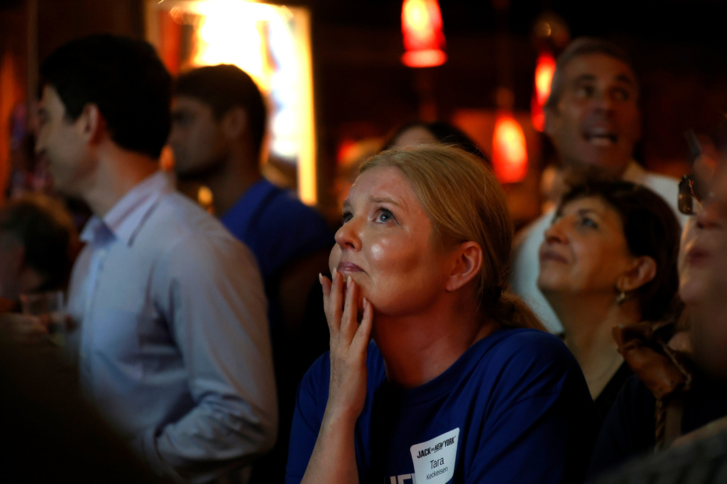 A supporter watches as Democratic congressional candidate Jack Schlossberg speaks during an election night watch party Tuesday, June 23, 2026, in New York. (AP Photo/Heather Khalifa)