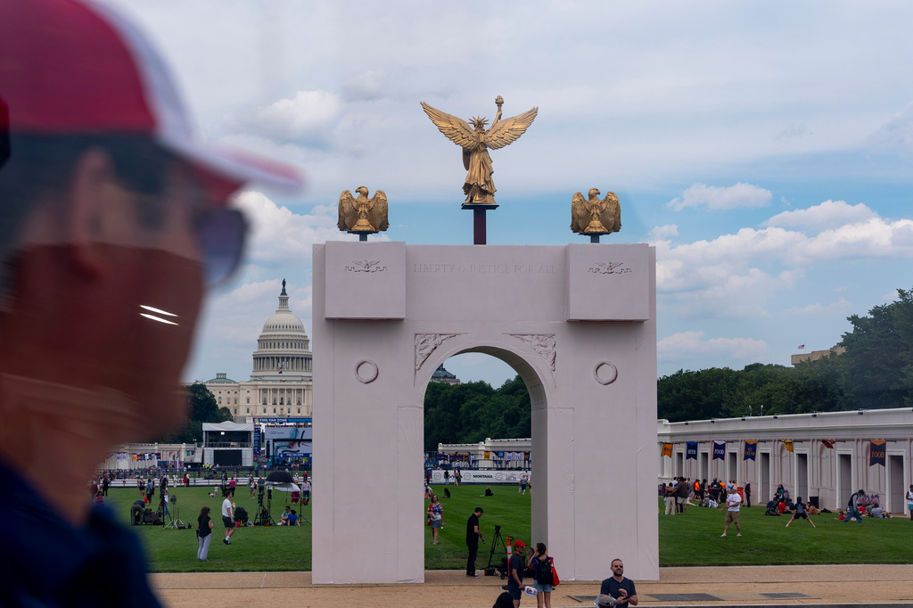The U.S. Capitol and a mock-up of President Donald Trump's proposed triumphal arch are seen from the ferris wheel at the Great American State Fair on the National Mall, Thursday, June 25, 2026, in Washington. (AP Photo/Jen Golbeck)