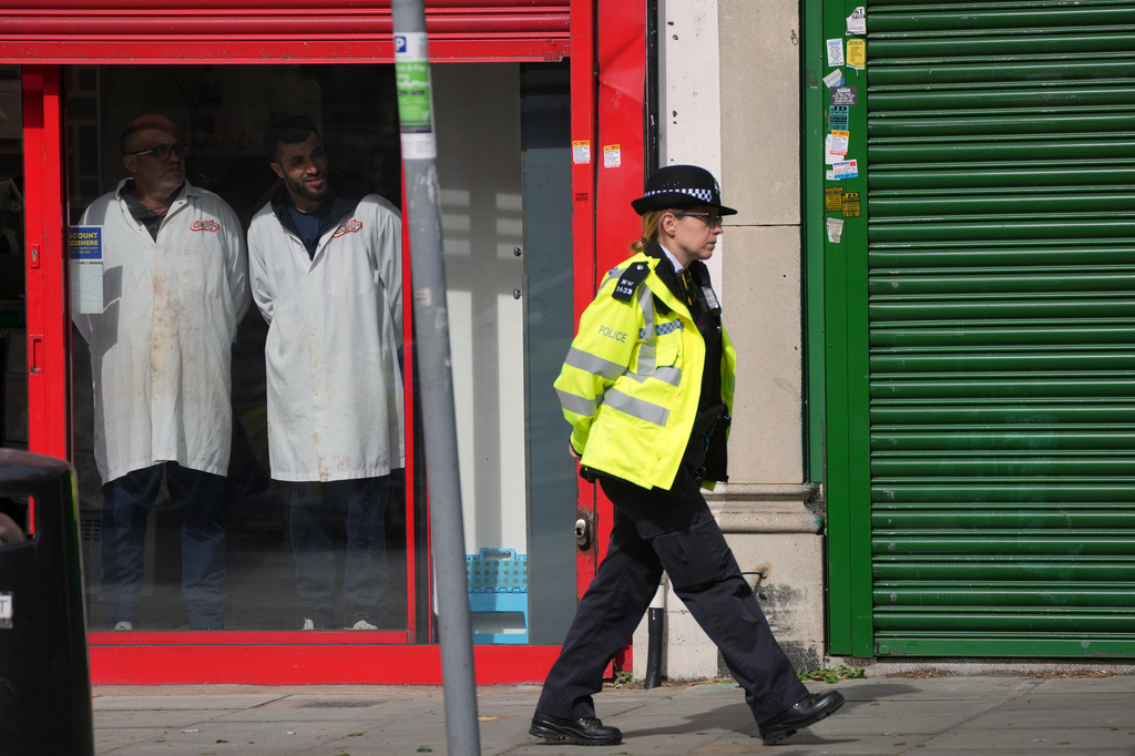 A Police officer patrols the high street after two people were stabbed in Golders Green neighbourhood, that has a large Jewish community, in London, Wednesday, April 29, 2026.(AP Photo/Kin Cheung)