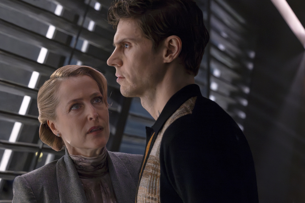 This image released by Disney shows Gillian Anderson, left, and Evan Peters in a scene from "Tron: Ares." (Disney via AP)