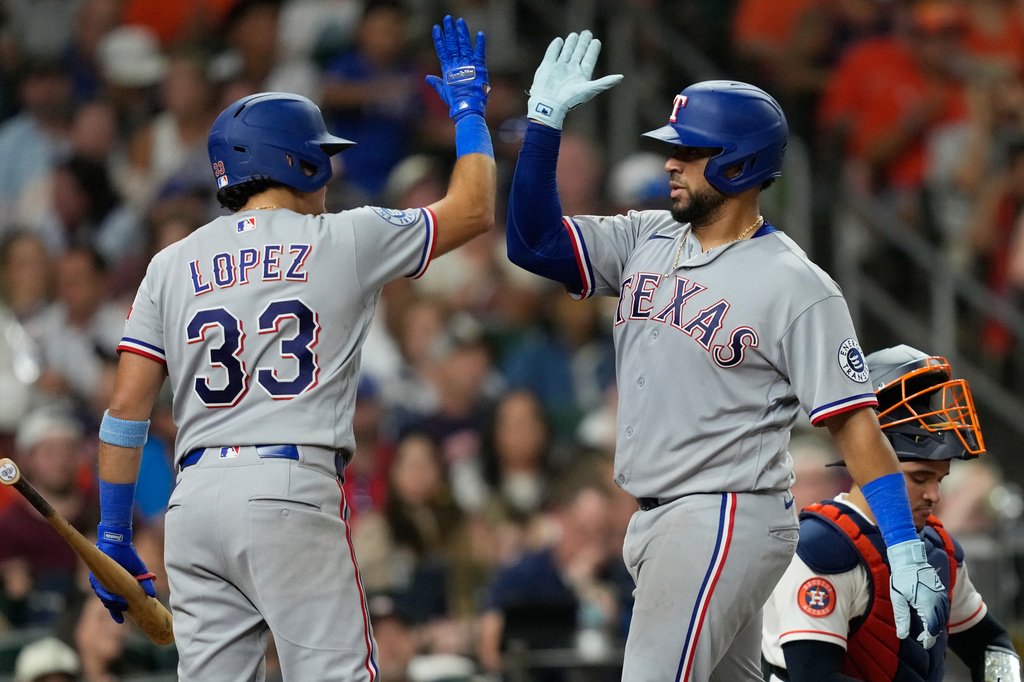 Texas Rangers' Elias Díaz, right, celebrates with Nicky Lopez (33) after hitting a home run against the Houston Astros during the sixth inning of a baseball game Saturday, Aug. 1, 2026, in Houston. (AP Photo/David J. Phillip)
