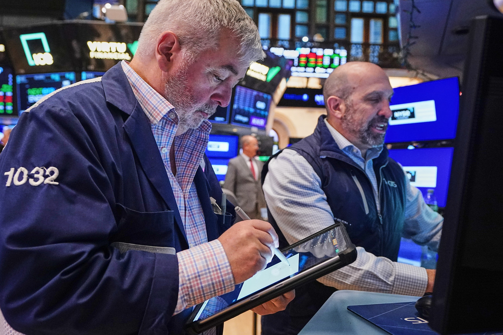 Trader Edward McCarthy, lefty dn specialist James Denaro work on the floor of the New York Stock Exchange, Wednesday, April 22, 2026. (AP Photo/Richard Drew)