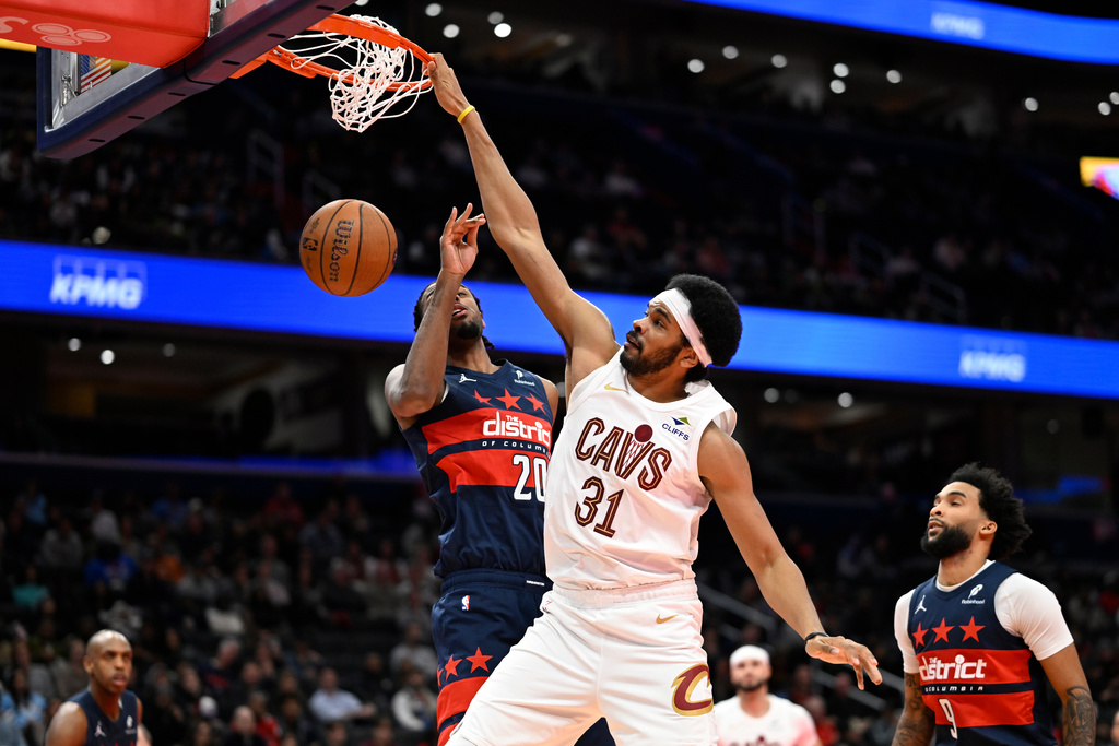 Cleveland Cavaliers center Jarrett Allen (31) dunks over Washington Wizards center Alex Sarr during the first half of an NBA Cup basketball game, Friday, Nov. 7, 2025, in Washington. (AP Photo/John McDonnell)