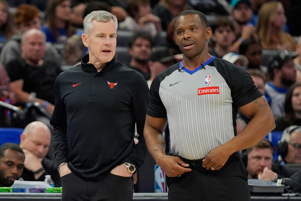 Chicago Bulls head coach Billy Donovan, left, talks with official Dedric Taylor during the first half of an NBA basketball game, Monday, Dec. 1, 2025, in Orlando, Fla. (AP Photo/John Raoux)