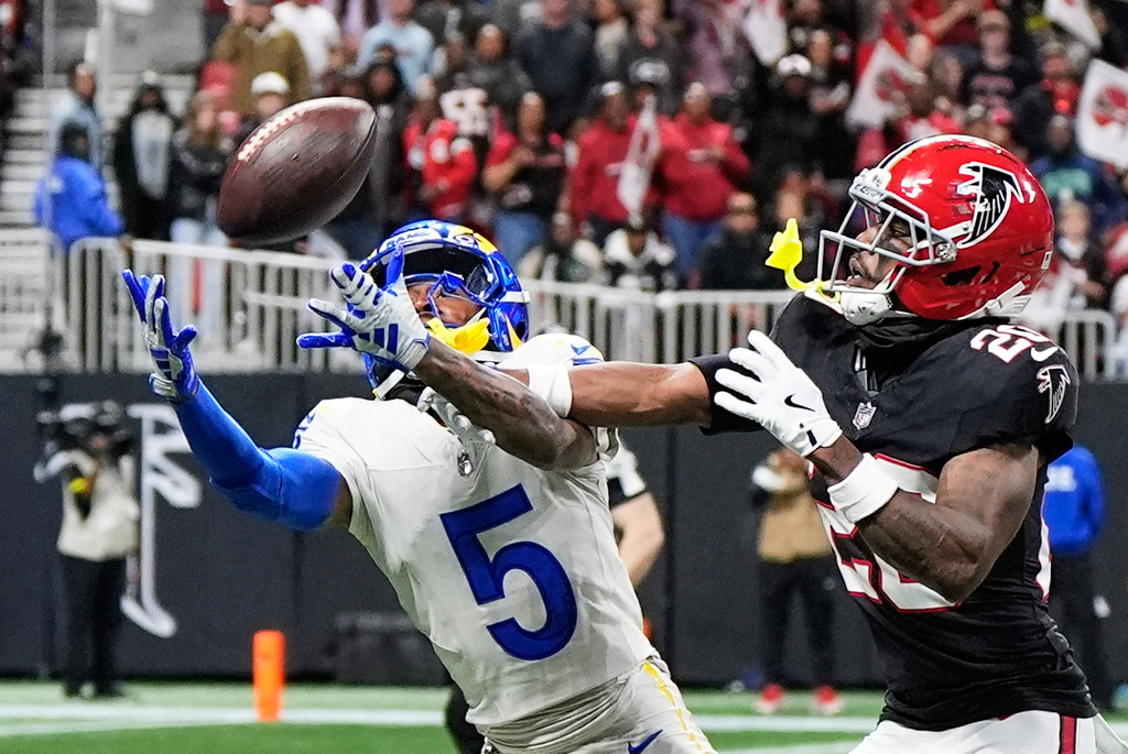 Los Angeles Rams wide receiver Tutu Atwell (5) can't pull in a pass as he is defended by Atlanta Falcons cornerback Dee Alford (20) in the second half of an NFL football game, Monday, Dec. 29, 2025, in Atlanta. (AP Photo/Brynn Anderson)