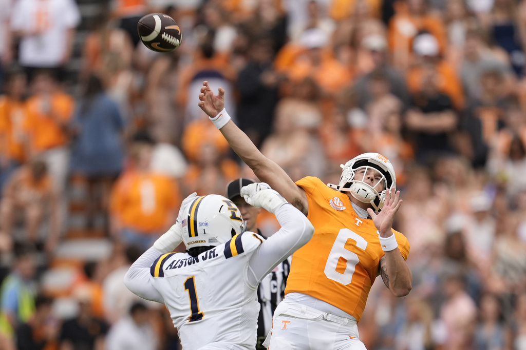 Tennessee quarterback Joey Aguilar (6) throws a pass over East Tennessee State defensive lineman Brian Alston (1) during the first half of an NCAA college football game Saturday, Sept. 6, 2025, in Knoxville, Tenn. (AP Photo/George Walker IV)