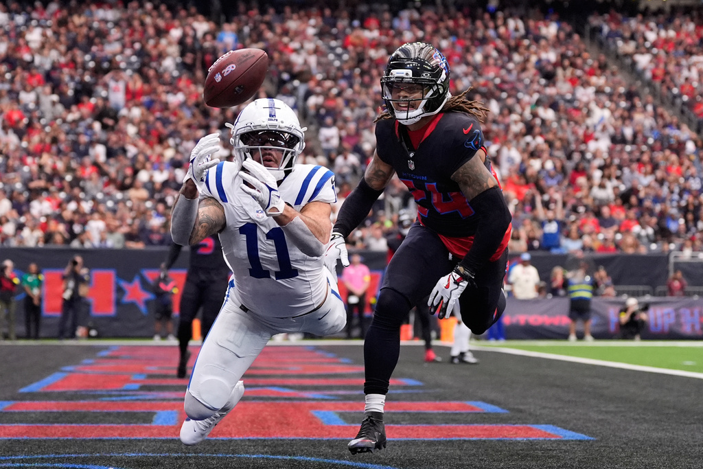 Indianapolis Colts wide receiver Michael Pittman Jr. (11) fails to make a catch in front of Houston Texans cornerback Derek Stingley Jr. (24) during the first half of an NFL football game in Houston, Sunday, Jan. 4, 2026. (AP Photo/Ashley Landis)