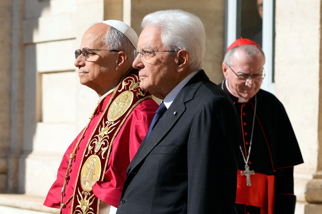 Pope Leo XIV, left, is welcomed by Italian President Sergio Mattarella as he arrives at the Quirinale Presidential Palace in Rome, Tuesday, Oct. 14, 2025. At right Vatican Secretary of State Cardinal Pietro Parolin. (AP Photo/Gregorio Borgia)