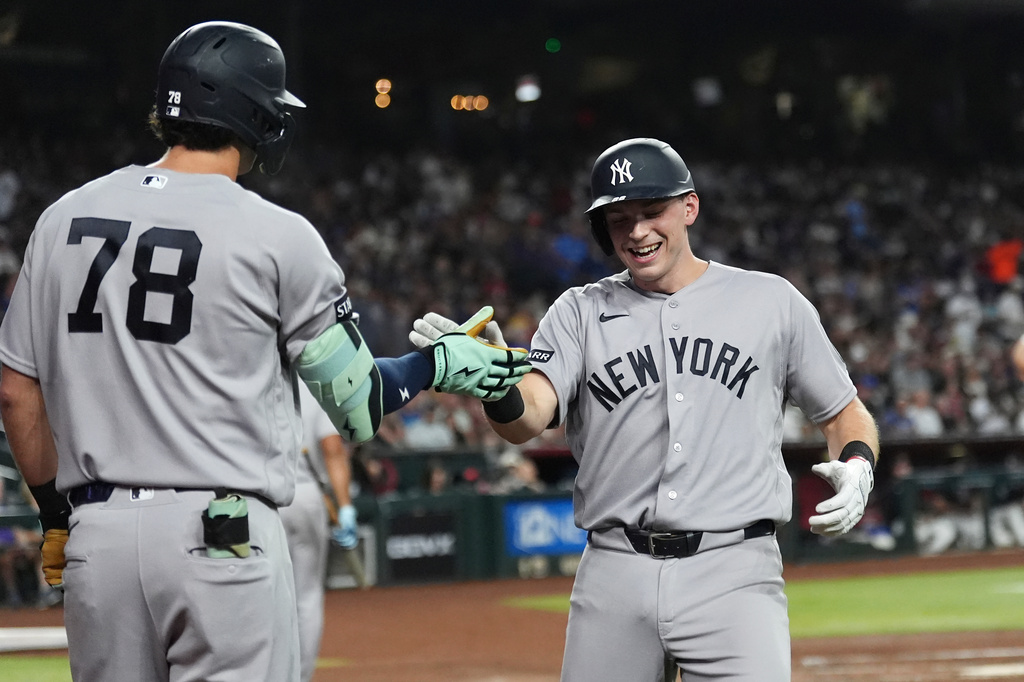 New York Yankees' Ben Rice, right, celebrates his home run against the Arizona Diamondbacks with Yankees' Spencer Jones (78) during the third inning of a baseball game, Friday, Sept. 18, 2026, in Phoenix. (AP Photo/Ross D. Franklin)