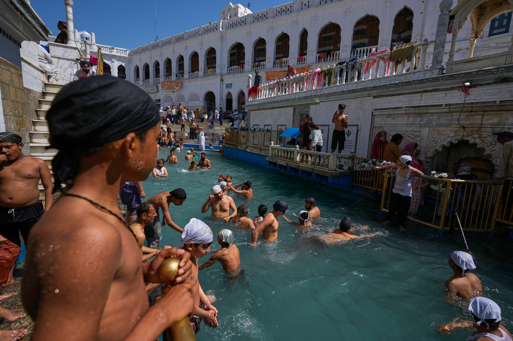 Sikh youth take holy dip in a pool during Vaisakhi festival, which also marks the New Year in Sikh tradition, at the shrine of Gurdwara Punja Sahib, the second most sacred place for Sikhs, in Hassan Abdal, Pakistan, Tuesday, April 14, 2026. (AP Photo/Anjum Naveed)