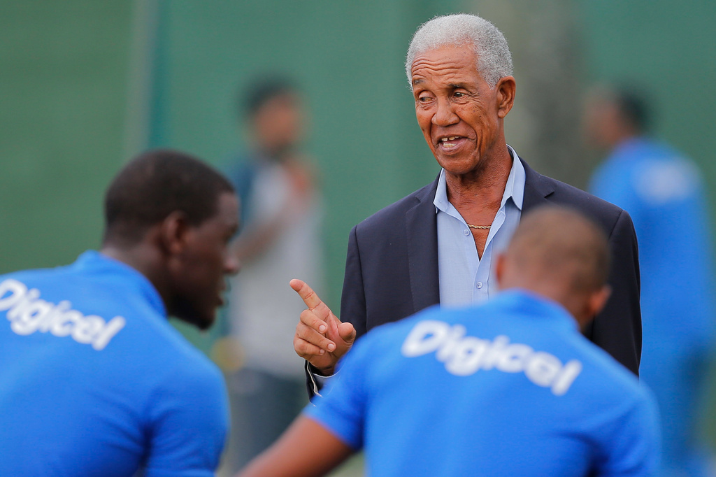 FILE - West Indies cricket great Garfield Sobers, right, chats with West Indies team members during a training session ahead of their second test cricket match against Sri Lanka in Colombo, Sri Lanka, Oct. 21, 2015. (AP Photo/Eranga Jayawardena, File)