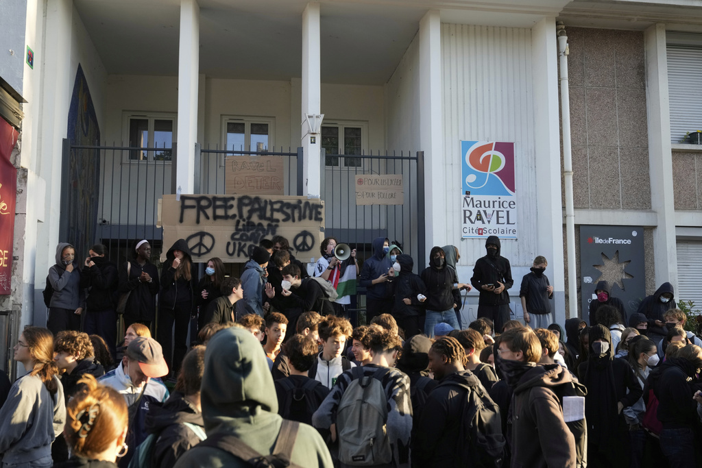 Students block the entrance of a school during a protest called by major trade unions to oppose budget cuts, in Paris, France, Thursday, Sept. 18, 2025. (AP Photo/Michel Euler)