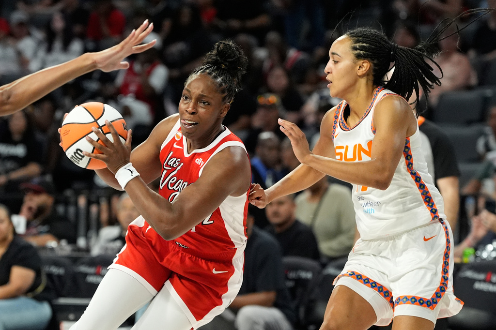 Las Vegas Aces guard Chelsea Gray (12) drives against Connecticut Sun guard Leila Lacan (47) during the second half of a WNBA basketball game Thursday, Aug. 20, 2026, in Las Vegas. (AP Photo/John Locher)