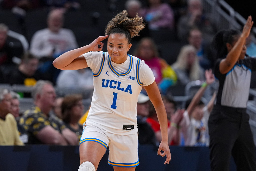 UCLA guard Kiki Rice (1) celebrates a three-point basket against Iowa in the first half of an NCAA college basketball game in the finals of the Big Ten Conference tournament, Sunday, March 8, 2026 in Indianapolis. (AP Photo/Michael Conroy)