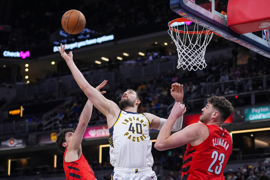 Indiana Pacers center Ivica Zubac (40) grabs a rebound over Portland Trail Blazers center Donovan Clingan (23) during the first half of an NBA basketball game in Indianapolis, Wednesday, March 18, 2026. (AP Photo/Michael Conroy)