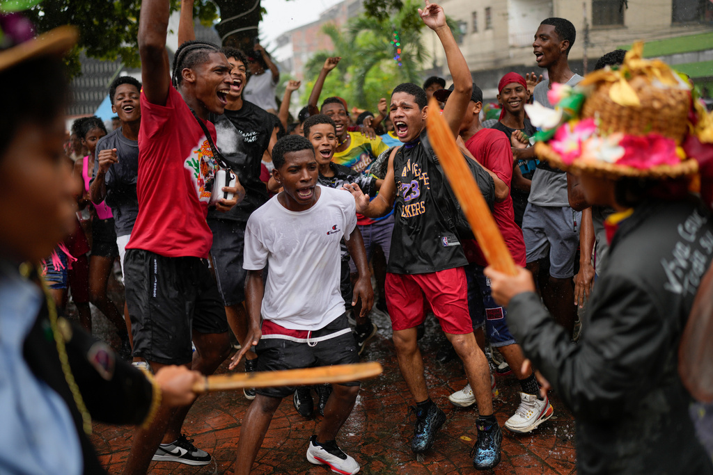 Revelers take part in the Afro-Venezuelan Holy Innocents' Day celebration in Caucagua, Venezuela, Sunday, Dec. 28, 2025. (AP Photo/Matias Delacroix)