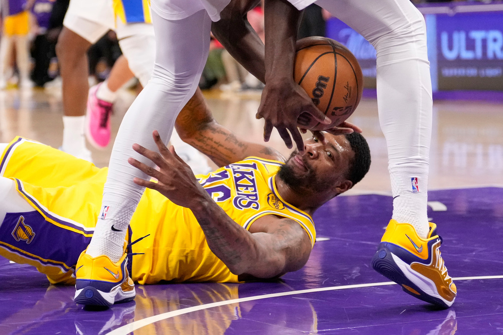 Los Angeles Lakers guard Marcus Smart, below, grapples for a loose ball with Indiana Pacers forward Pascal Siakam during the third period of an NHL hockey game Friday, March 6, 2026, in Los Angeles. (AP Photo/Mark J. Terrill)