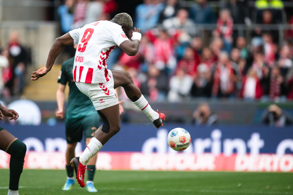 Koln's Ragnar Ache scores his side's second goal during German Bundesliga soccer match between 1. FC Koln and Werder Bremen and Werder Bremen, in Cologne, Germany, Sunday, April 12, 2026. (Marius Becker/dpa via AP)