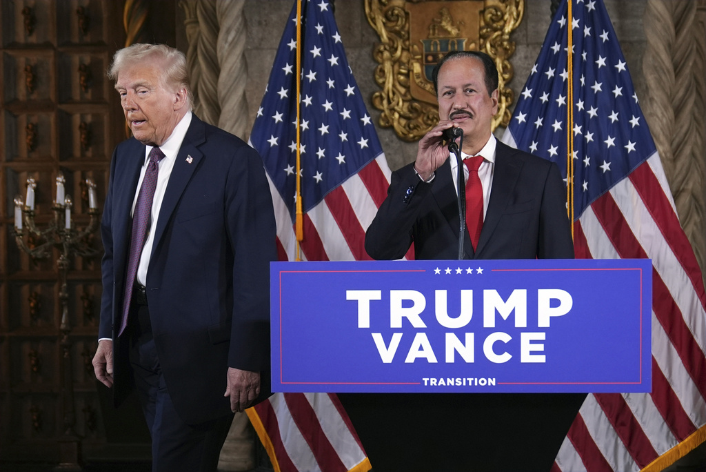 Hussain Sajwani, CEO of DAMAC Properties, speaks as President-elect Donald Trump listens during a news conference at Mar-a-Lago, Tuesday, Jan. 7, 2025, in Palm Beach, Fla. (AP Photo/Evan Vucci)
