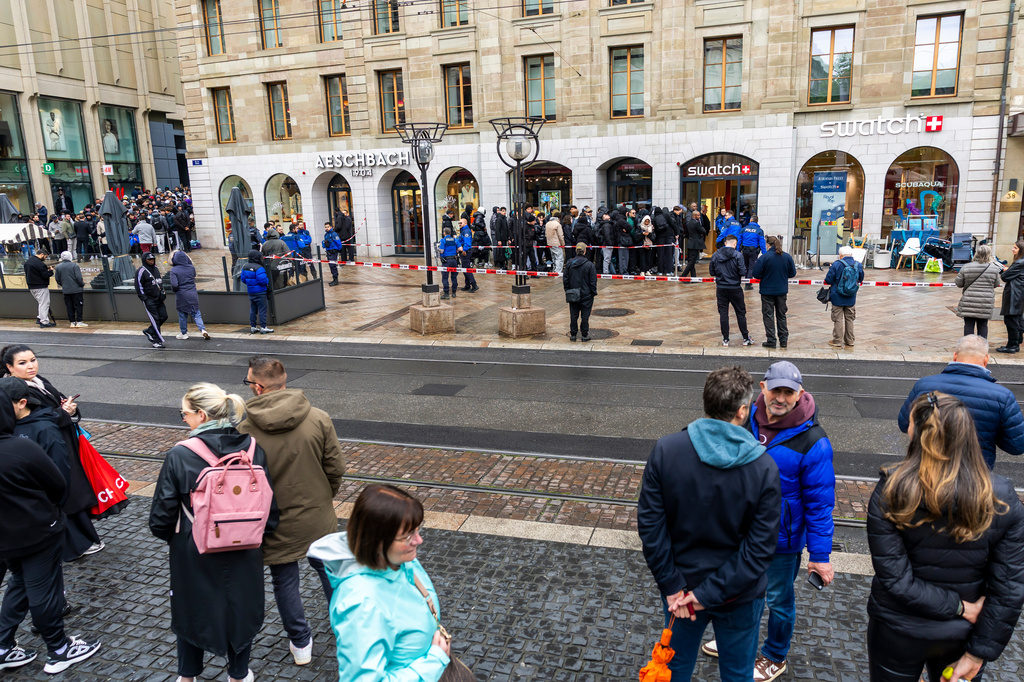 Swiss police officers secure the area where customers queue to buy the new Royal Pop watch by Swatch and Audemars Piguet, in Geneva, Switzerland, Saturday, May 16, 2026. (Salvatore Di Nolfi/Keystone via AP)